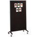 A black Quartet room divider with whiteboard and fabric bulletin board surfaces.