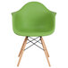 A green Flash Furniture Alonza plastic chair with wooden legs.