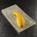 A yellow squash on an Elite Global Solutions sandstone rectangular tray.