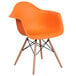 An orange plastic Flash Furniture Alonza chair with wood legs.