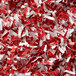 Shredded red and white paper in front of a Swingline Micro-Cut Shredder.