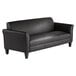 A black leather Alera couch with wooden legs.