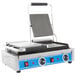 A Globe Bistro Series double sandwich grill with smooth plates and a blue handle.