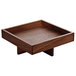 A Playground Ananti walnut wood square tray on a stand.