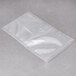 A clear plastic ARY VacMaster vacuum packaging bag on a grey surface.