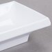 A white square GET Water Lily melamine sauce dish.
