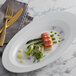 A Schonwald bone white porcelain platter with lobster and asparagus on it.