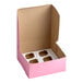 A pink cardboard cupcake or muffin box with an open lid and a white insert featuring six slots for holding baked goods.