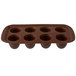 A brown silicone Wilton cake pop mold with eight compartments.