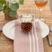 A table setting with an Avery Matte Ivory Business Card with a pine cone and a glass of wine.