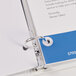 A binder with a white label reinforced with Avery white round labels.