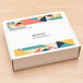 A package of Avery clear full sheet shipping labels with a white box with colorful designs on it.