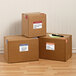 Several cardboard boxes with Avery white removable moving labels on a wood floor.