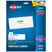 A blue box of white Avery address labels.