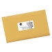 A yellow envelope with a white rectangle shipping label on it.