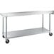 A stainless steel Regency work table with wheels.