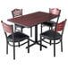 A Lancaster Table & Seating cherry table with black and red reversible top and four mahogany bistro chairs with black padded seats.