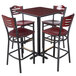 A Lancaster Table & Seating bar height table with a reversible cherry/black top and mahogany chairs with wood seats.
