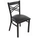 A black Lancaster Table & Seating cross back chair with a black cushion.