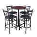 A Lancaster Table & Seating bar height table with a cherry top and black base, surrounded by black chairs with padded seats.