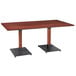 A Lancaster Table & Seating rectangular wooden dining table with black legs.