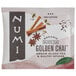 A Numi Organic Golden Chai tea bag packet with cinnamon sticks.