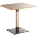 A Lancaster Table & Seating dining table with a wooden top and metal base.
