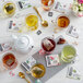 A glass of Numi Organic Emperor's Pu-Erh Tea with a tea bag in it on a table.