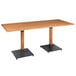 A Lancaster Table & Seating solid wood live edge dining table with black metal legs.
