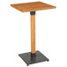 A Lancaster Table & Seating square wooden bar height table with a live edge and black metal base.