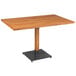 A Lancaster Table & Seating wooden table with a metal base.