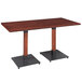 A Lancaster Table & Seating wooden dining table with black legs.