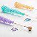 A group of Avery glossy white mailing labels on a counter with colorful rock candy sticks.