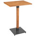 A Lancaster Table & Seating live edge bar height table with a wooden top and metal base.