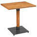 A Lancaster Table & Seating wooden table with a metal base.