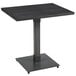 A black Lancaster Table & Seating solid wood table with a metal base.