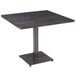 A Lancaster Table & Seating square wood table with a metal base.