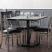 A Lancaster Table & Seating solid wood dining table with a slate gray finish.
