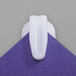 A close up of a white Advantus StikkiClip on a purple square.