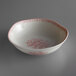 A white Oneida porcelain bowl with pink and red floral designs.