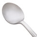 A close-up of a WNA Comet Reflections heavy weight plastic soup spoon with a silver handle.