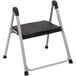 A black and silver Cosco folding step stool.