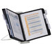 A Durable black letter-sized expandable desktop reference system with papers in it.