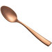 A close-up of a Bon Chef rose gold matte teaspoon with a handle.