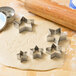 Cookie dough with star shaped cutters on it.