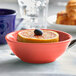 A Tuxton Cinnebar china nappie bowl filled with a grapefruit and orange slices.