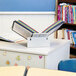 A white table with a Durable VARIO file folder system and books on it.