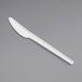 A EcoChoice white CPLA plastic knife on a gray background.