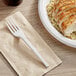 A plate of chicken and rice with a white EcoChoice compostable CPLA plastic fork.