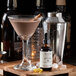 A glass of brown liquid with a Woodford Reserve Chocolate Bitters drink garnished with cinnamon.